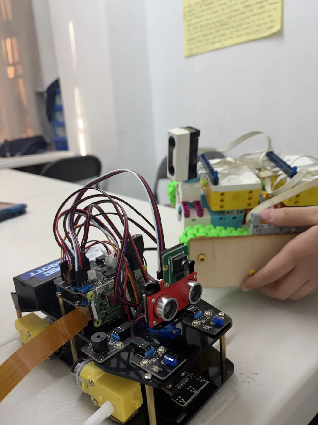 Wooden rover beside electronics prototype